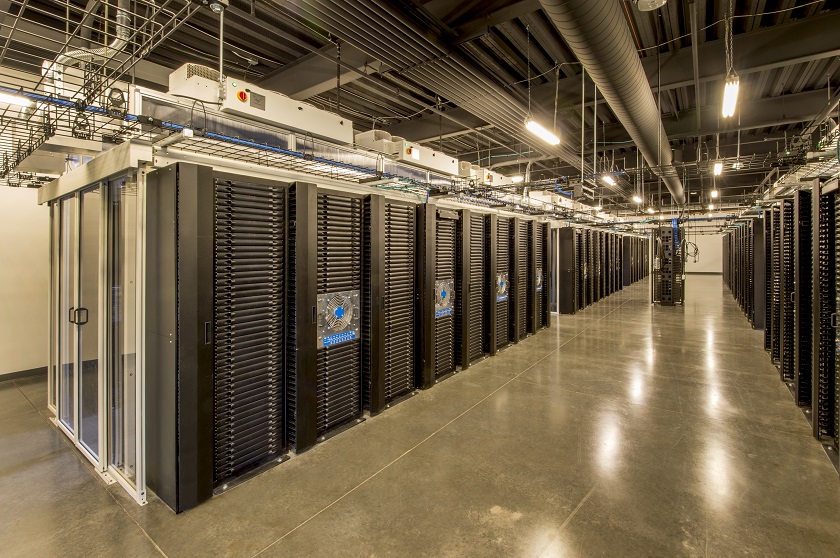 Large server room with enclosed, climate controlled server racks.